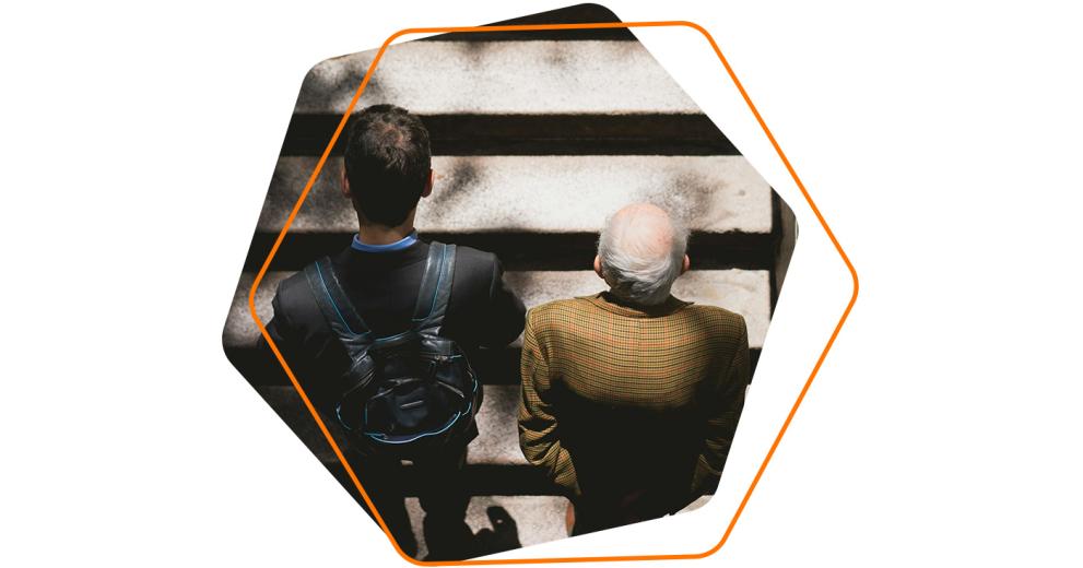 Image of a young man and an old man walking together